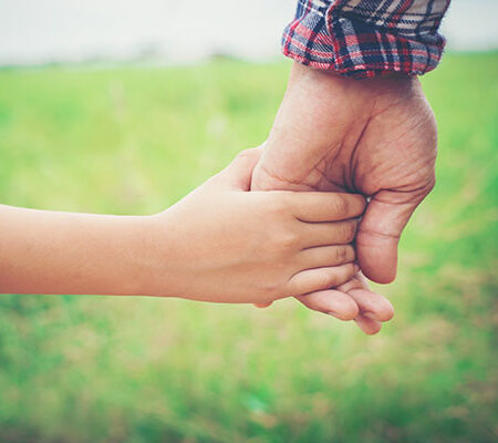 Close up of father holding his daughter hand, so sweet,family time.